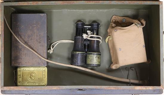 A military tin containing field binoculars and other militaria